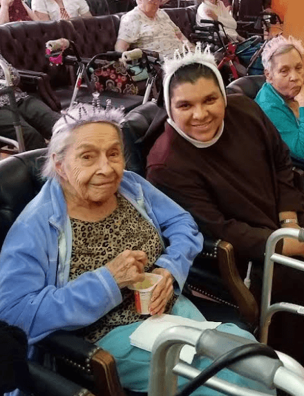 A resident celebrating with family at a festive community party